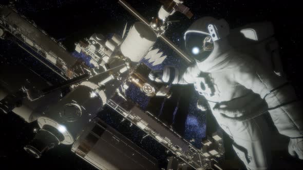 Astronaut Outside the International Space Station on a Spacewalk alt