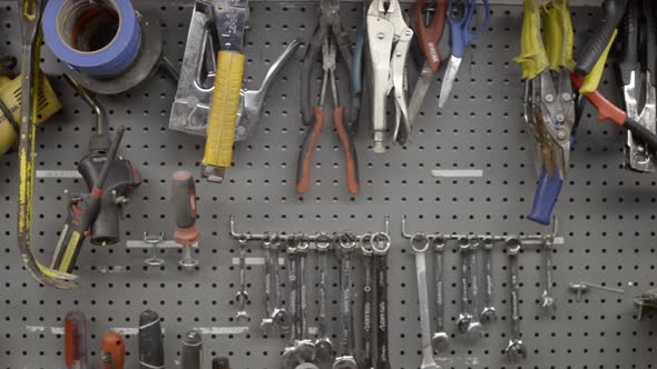 Hand tools hang on a workshop wall