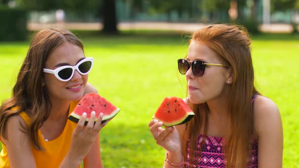 Teenage Girls Eating Watermelon at Picnic in Park