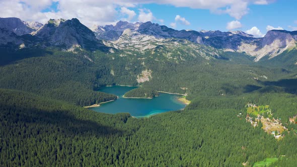 Aerial View on Black Lake with Pine Forest on Mountains in National Park Durmitor Montenegro