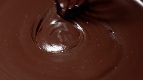 Chef Stirring Mixing Melted Liquid Premium Dark Chocolate with Whisk Preparation of Handmade Candies