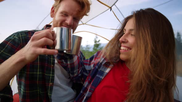 Couple Sitting in Tent Together