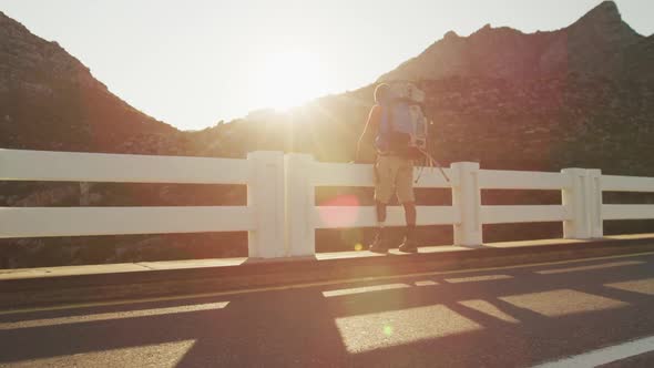 Sporty mixed race man with prosthetic leg hiking