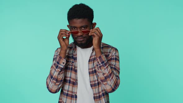 Playful Happy Man Wearing Sunglasses Blinking Eye Looking at Camera with Smile Winking Flirting