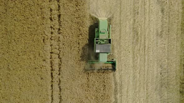 Agricultural machines working in farmland during harvesting. Farming concept. Top view.