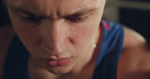 Macro Portrait of Sweaty Athlete Catching Breathes and Looking Into Camera