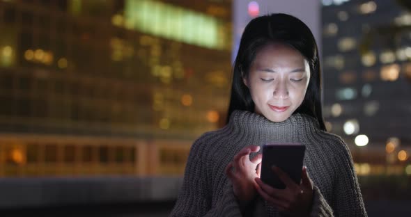 Woman Working on Smart Phone at Night