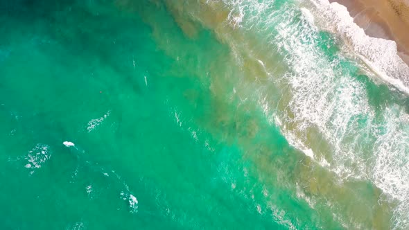 Aerial View of the Mediterranean Coast Waves Reach the Deserted Sandy Beach