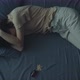 A Woman Lies in Bed with Her Hands to Her Head - VideoHive Item for Sale
