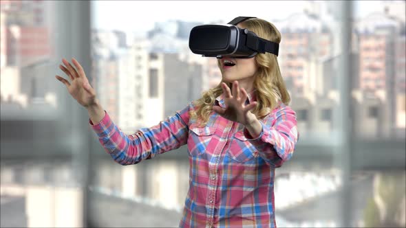 Happy Woman Getting Experience Using VRheadset Glasses in a Bright Room