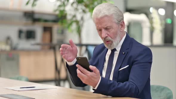 Sad Senior Old Businessman Having Failure on Smartphone