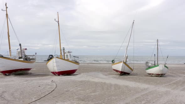 Old Fishing Boats Lined Up Ashore on Thorup Strand Beach in Denmark