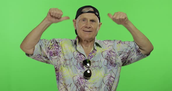 Senior Man Tourist in Colorful Shirt Dances. Handsome Old Man on Chroma Key