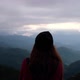 Slow motion blurred of a female traveler looking at a beautiful mountains view on foggy day - VideoHive Item for Sale