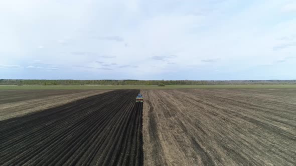 Aerial view of a blue tractor plant potatoes. 07