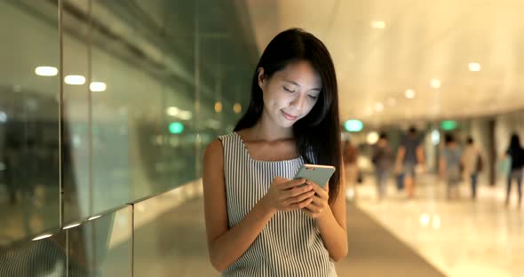 Woman using cellphone and walking in the city 