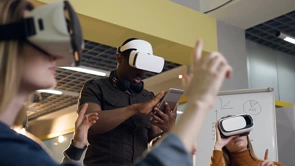 Concentrated Business Man in Virtual Reality VR Glasses Working in the Office