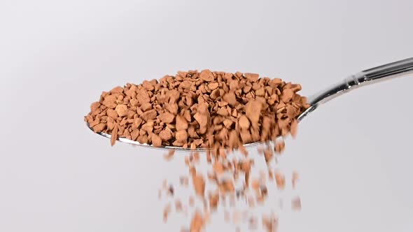 Pouring freeze-dried instant coffee from spoon