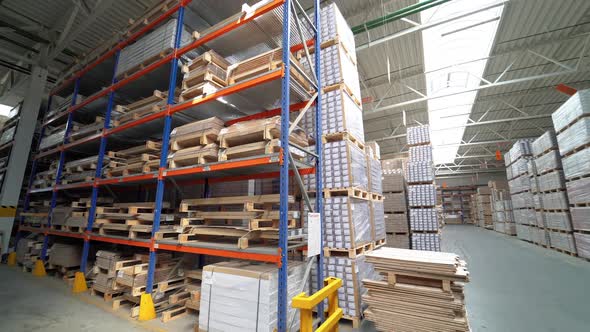Shelves of warehouse are filled with parquet. Stock of woodworking factory.