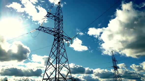 Power Lines And Blue Sky Time Lapse. High Voltage Electricity Transmission Pylon. Voltage Electric.