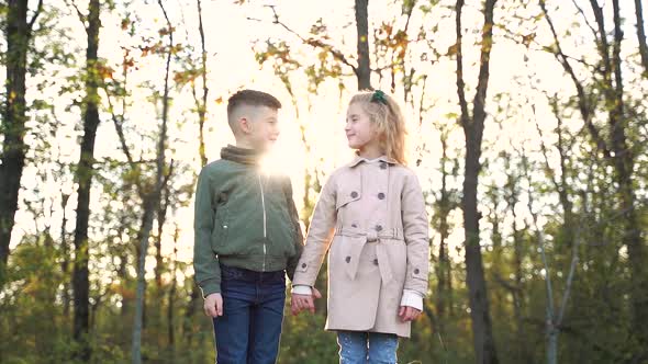 Little Couple Holding Hands in Forest