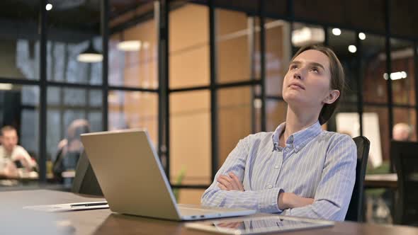 Positive Young Woman Sitting at Work