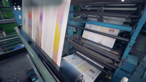 Newspaper Moving on a Printing Conveyor, Close Up.