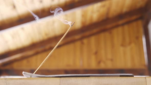 Incense Stick Smokes on a Wooden Table on a Terrace for Pleasant Smells and From Insects