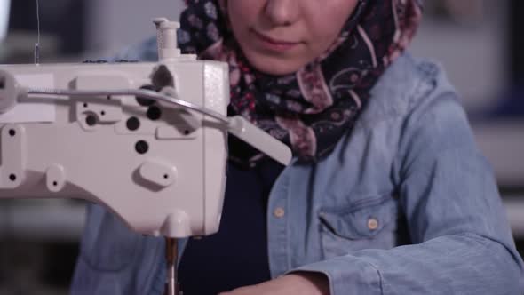 Ethnic woman sewing American Flag