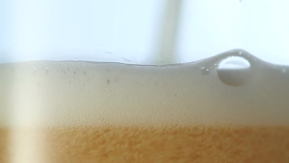 Pouring light beer into glass. Closeup view