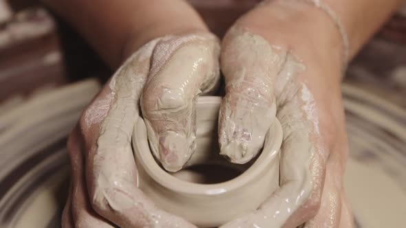 Pottery Workshop  Wet Female Hands Shaping the Clay on the Wheel