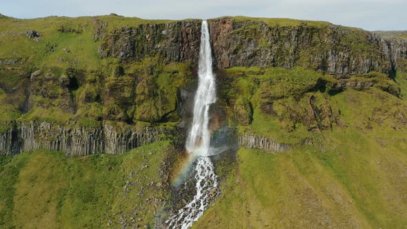 Aerial Drone Footage of Bjarnarfoss Waterfall with Its Green Cliffs in Western Iceland