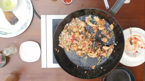 Mixing Paella and Seafood in a Pan, Cooking