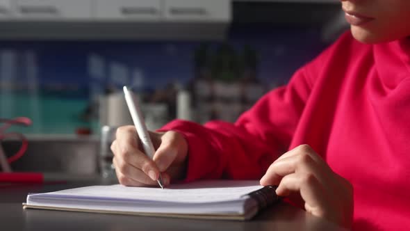 Young Woman Making Notes Close Up View