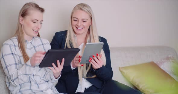 Businesswomen Discussing Over Technologies In Office