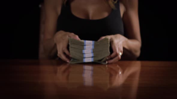 Sexy woman with a stack of money