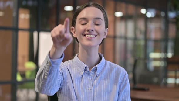 Portrait of Young Woman Pointing at the Camera