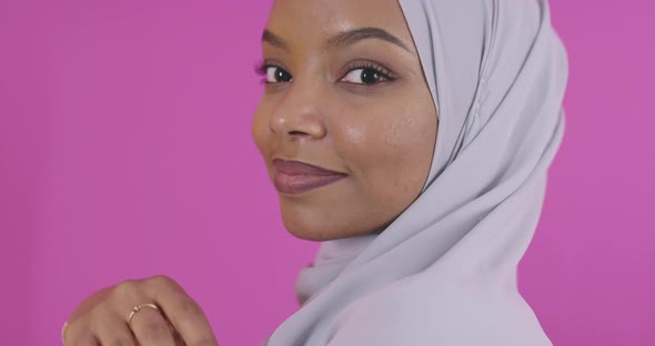 Portrait of Young Modern Muslim Afro Beauty Wearing Traditional Islamic Clothes on Plastic Pink