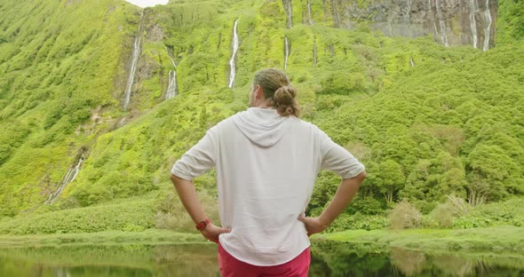 Caucasian Man with Hands on the Belt Enjoys the Nature