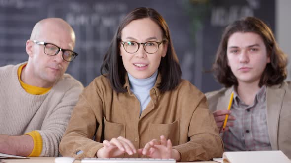 Three Businesspeople Working on Computer and Discussing Project