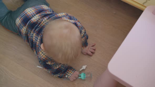 Baby Plays with Part of Medical Tool Scrawling on Floor