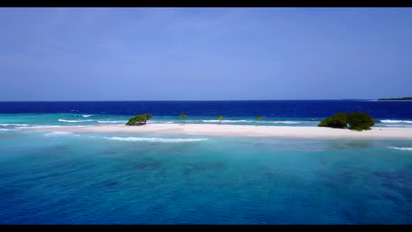 Aerial drone view texture of idyllic coastline beach lifestyle by shallow lagoon and white sand back