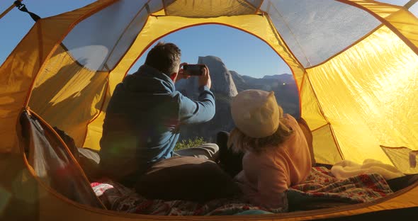 A Couple in Love Takes a Selfie in a Yellow Touristic Tent at a Dawn in Yosemite Valley. USA