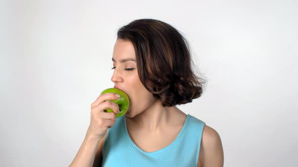 Portrait of Beautiful Woman Eating Apple