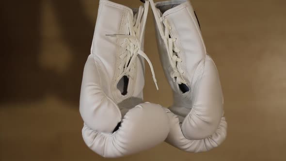 White Boxing Gloves Hanging On Laces