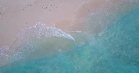 Natural overhead abstract view of a white sand paradise beach and aqua turquoise water background in