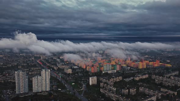 Aerial View of a Big Dark City After Rain Cloudy Sky and Smog Cars Driving Along Streets with