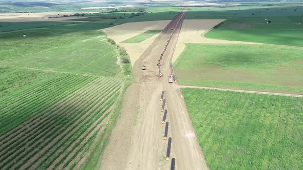 Aerial view of gas and oil pipeline construction. Pipes welded together.