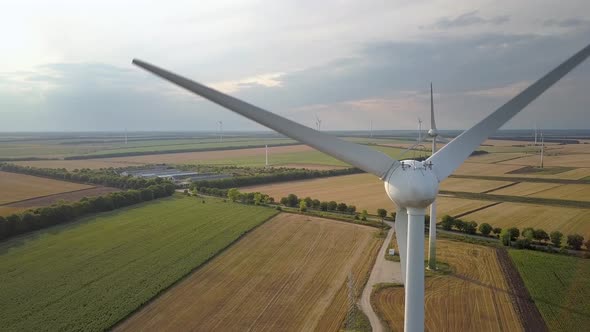 Aerial view of wind turbine generators in field producing clean ecological electricity.