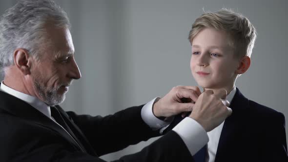 Mature Father Adjusting Little Sons Tie, Proud of Kid, Future Business Successor